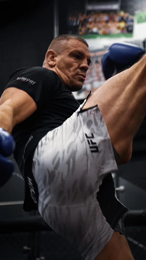 Combat sports athlete practising a high kick