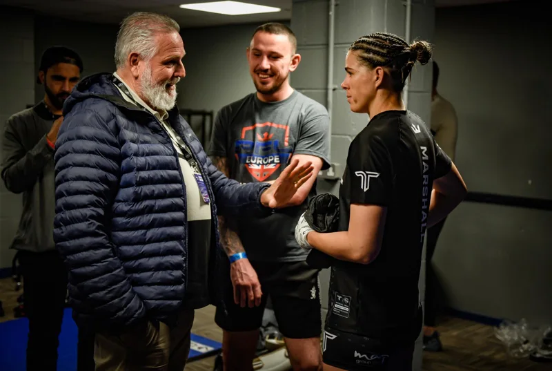Athlete speaking with a team backstage