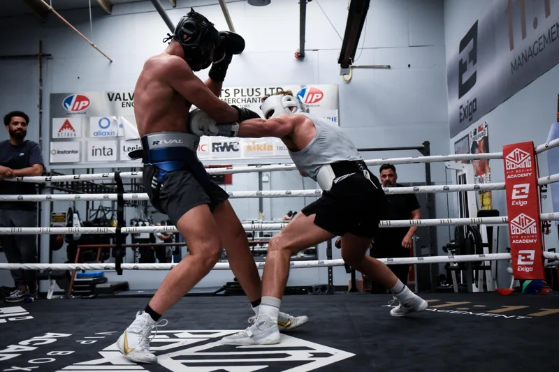 Boxers sparring in protective headgear