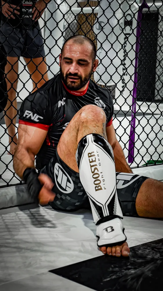 Athlete resting against the training cage