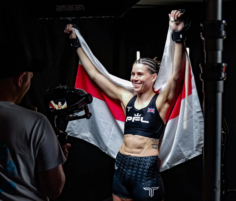 Athlete holding a flag for the camera