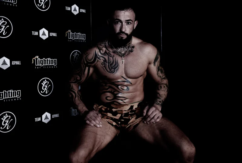 Seated athlete portrait against the gym backdrop