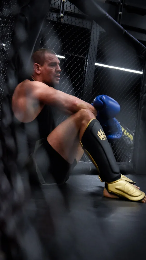 Athlete resting beside the training cage