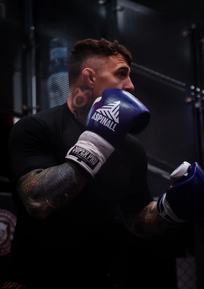 Close-up of a boxer training in blue gloves