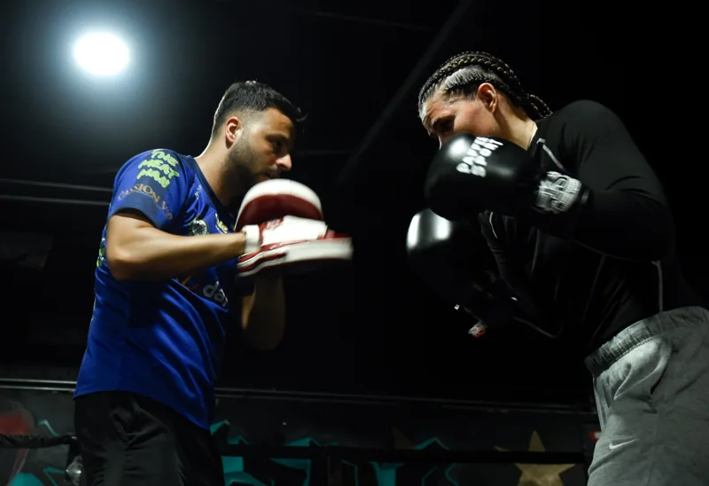 Boxer and coach working through a pad session