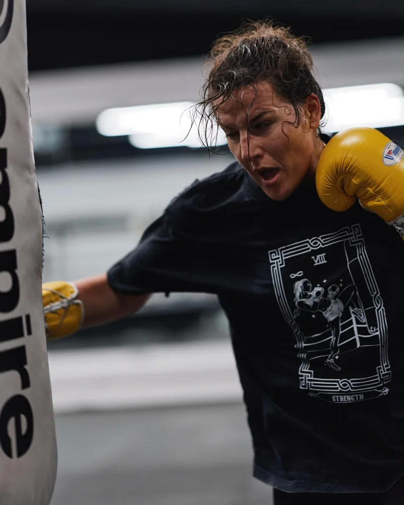 Boxer in yellow gloves working a punch bag