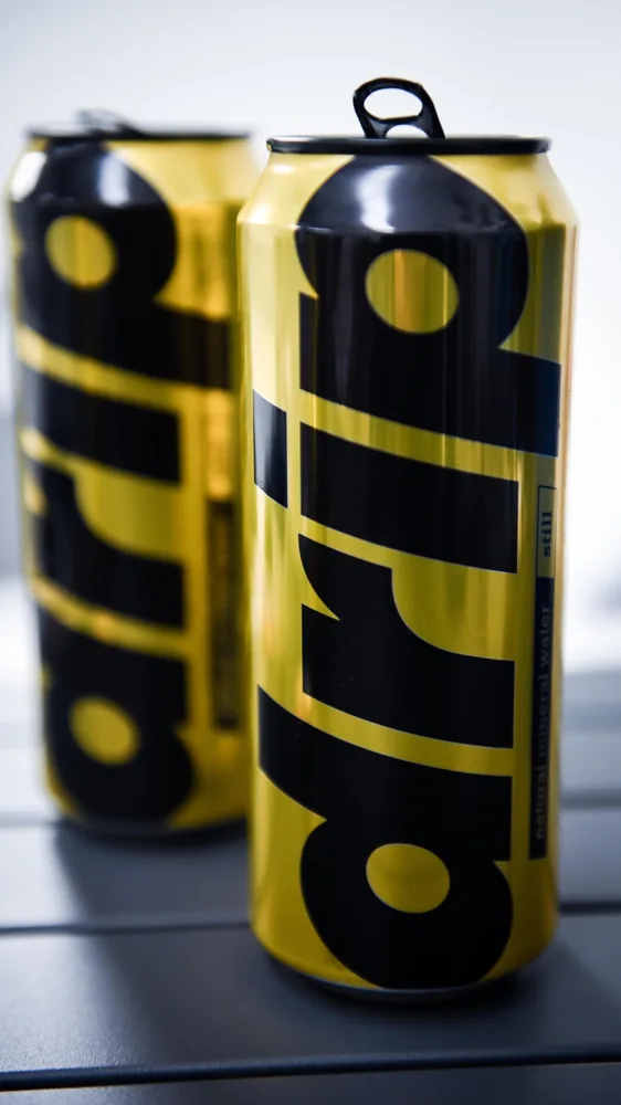 Product photograph of two gold Drip water cans