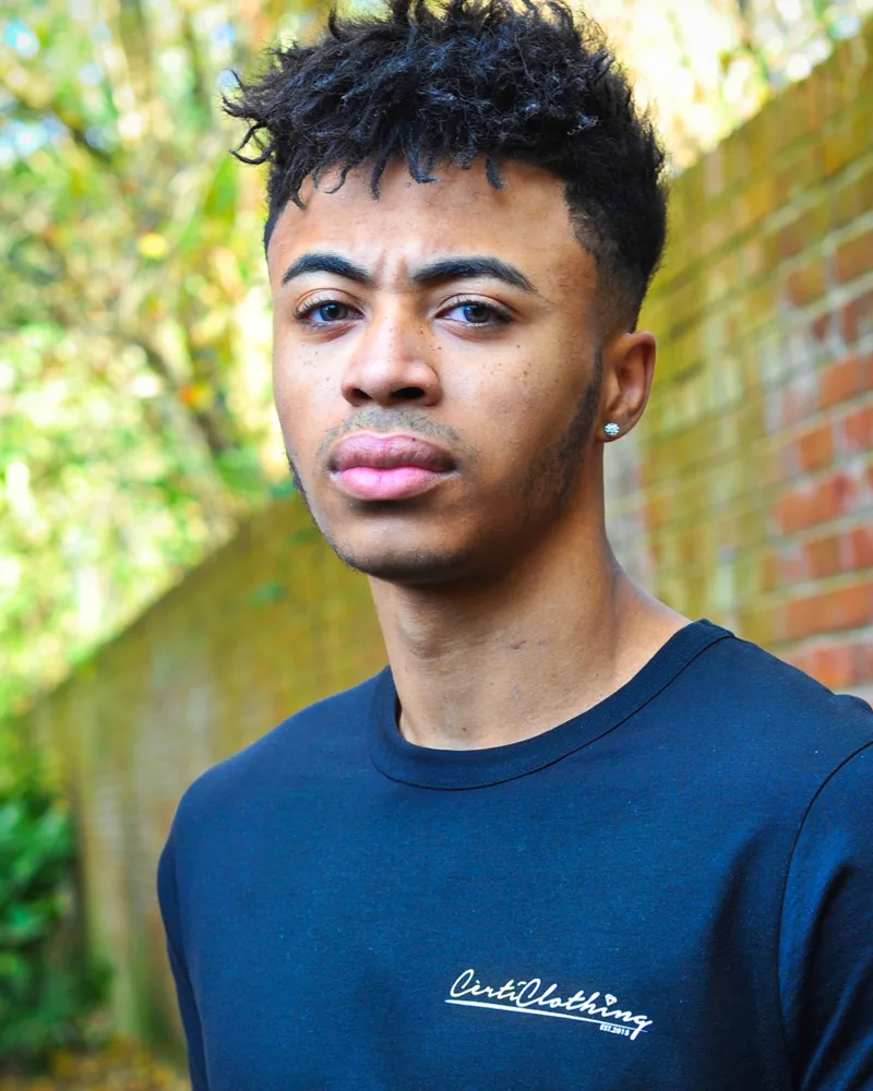 Outdoor portrait featuring a navy branded T-shirt