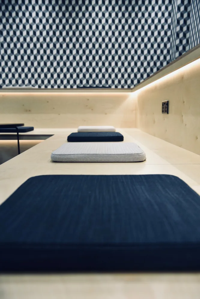 Built-in seating with blue cushions and geometric wall tiles