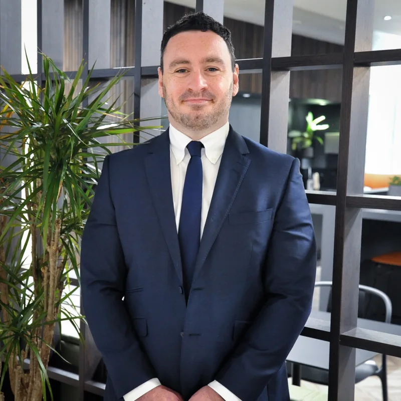 Corporate portrait of a team member in a navy suit