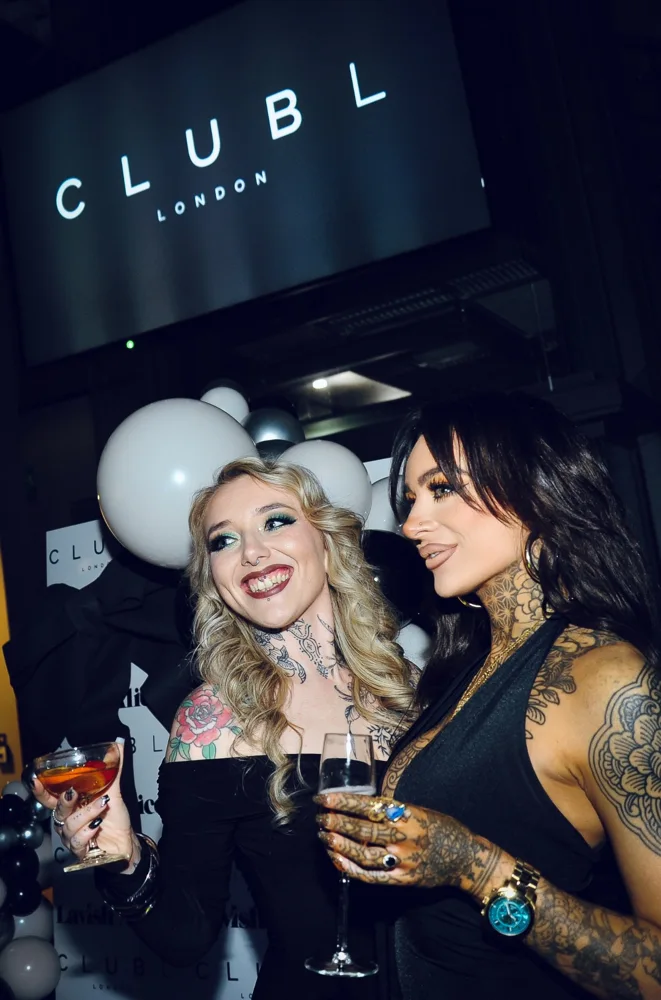 Two guests enjoying drinks at a launch party