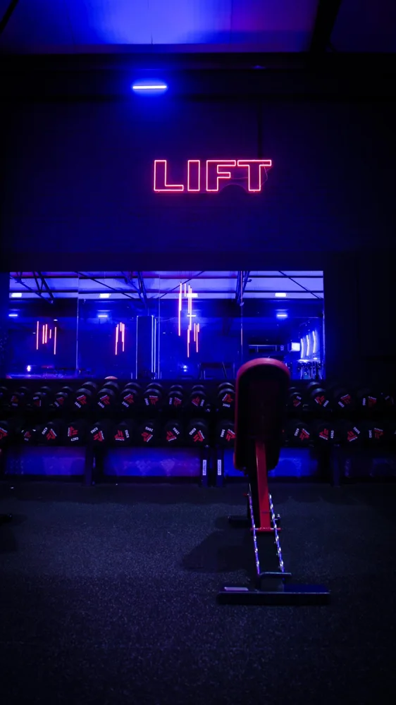 Gym weights area with neon lighting