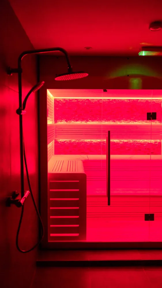 Sauna and shower illuminated with red lighting