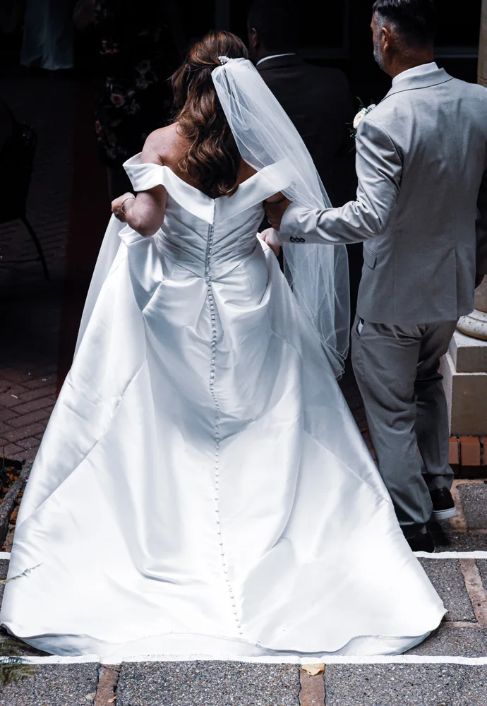 Bride and companion entering the wedding venue