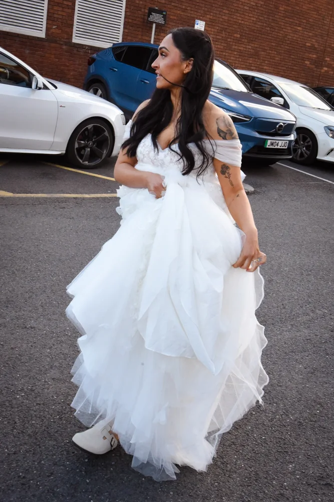 Bride in an off-the-shoulder wedding dress outdoors