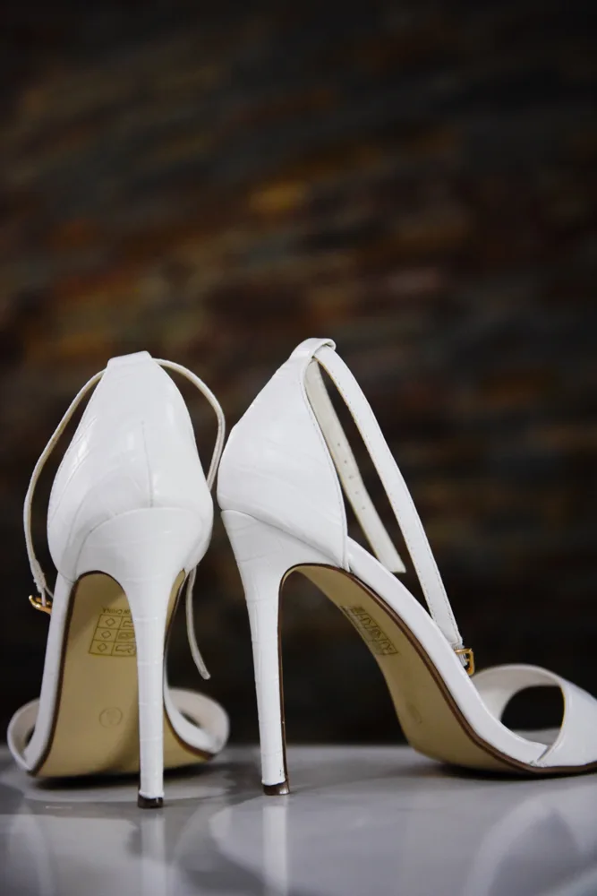 White bridal heels photographed in natural light